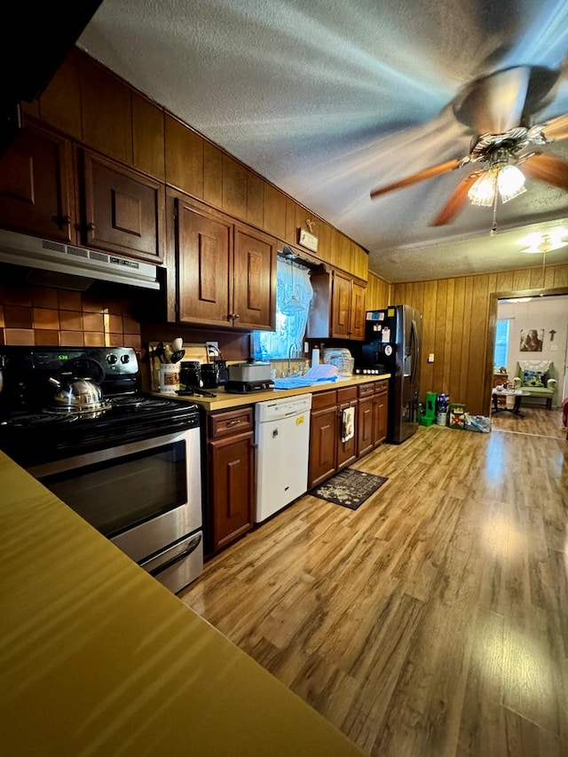 kitchen with black fridge with ice dispenser, stainless steel range with electric cooktop, a textured ceiling, light wood-type flooring, and dishwasher