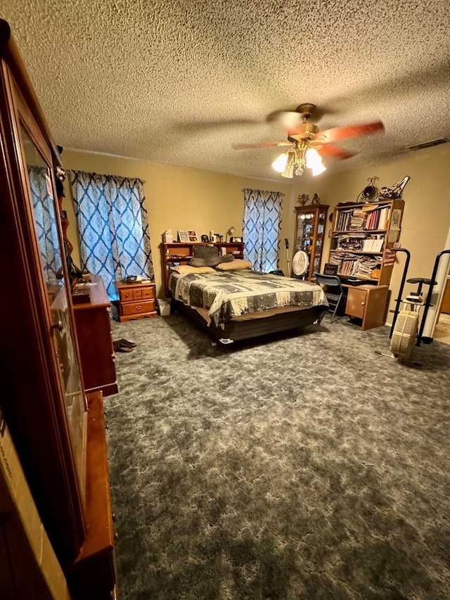 carpeted bedroom with a textured ceiling and ceiling fan