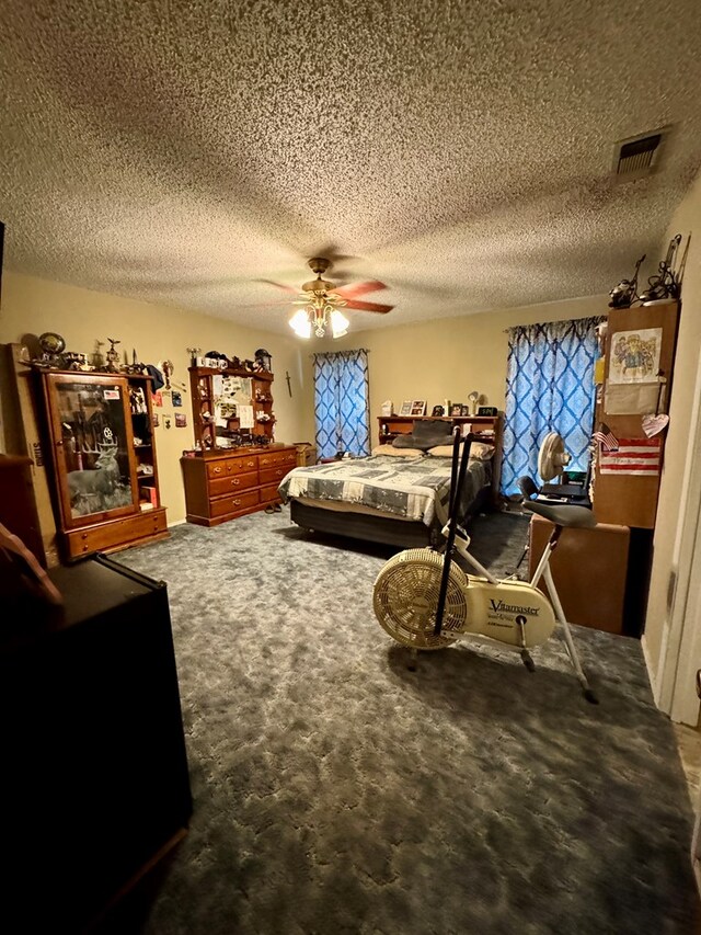 bedroom featuring carpet flooring, a textured ceiling, and ceiling fan