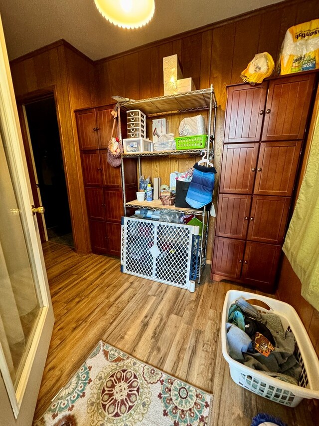 kitchen featuring light hardwood / wood-style floors and wood walls