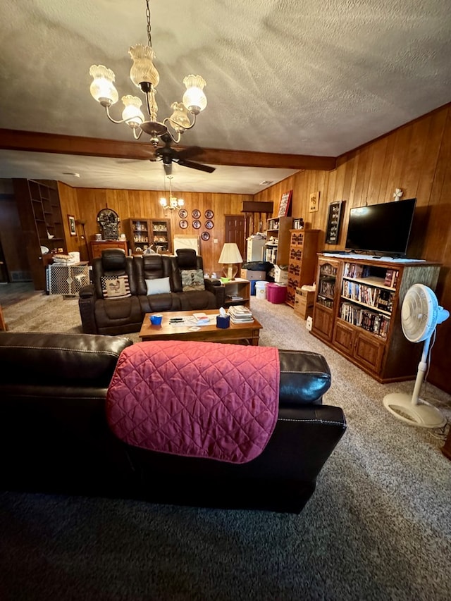 carpeted living room featuring an inviting chandelier, beamed ceiling, a textured ceiling, and wood walls