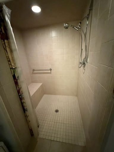 bathroom featuring tile patterned floors and tiled shower