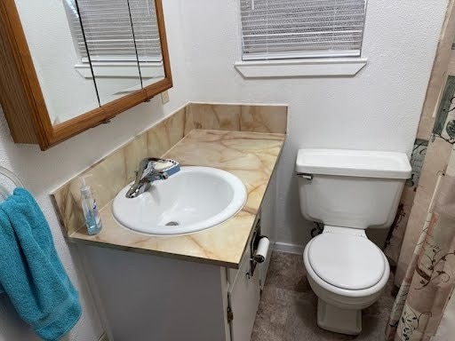 bathroom featuring toilet and vanity