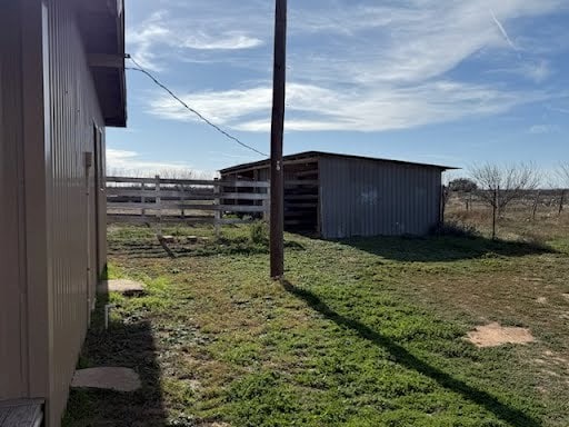 view of yard featuring an outbuilding and a rural view