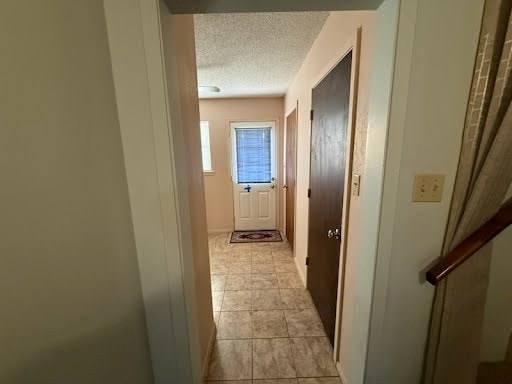 hall with a textured ceiling