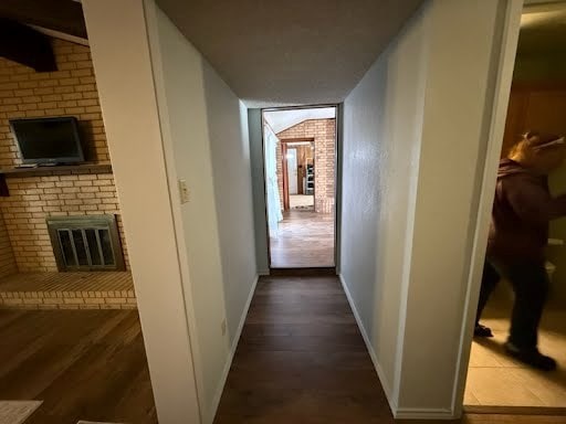 corridor featuring dark hardwood / wood-style flooring