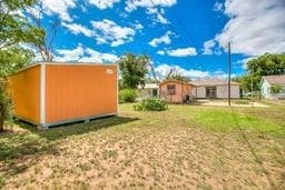 1246 E 20th St, San Angelo, TX 76903 - view of green lawn with a storage unit