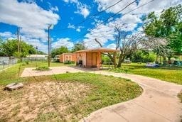 1246 E 20th St, San Angelo, TX 76903 - view of community featuring a yard and a storage unit