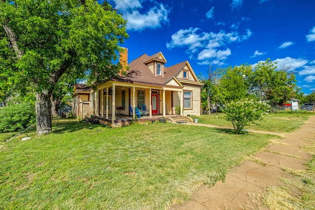 view of front facade with covered porch and a front lawn