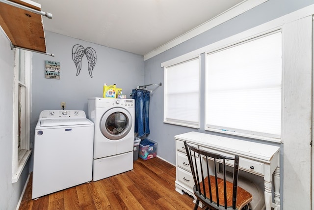 laundry room with ornamental molding, dark hardwood / wood-style floors, and washer and clothes dryer