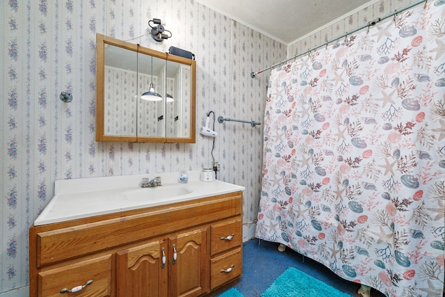 bathroom with ornamental molding, vanity, and a textured ceiling