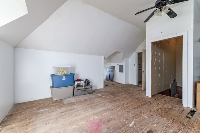 living room with vaulted ceiling, ceiling fan, and light wood-type flooring