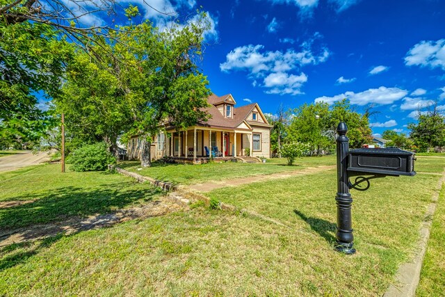 view of front of house with a porch and a front lawn