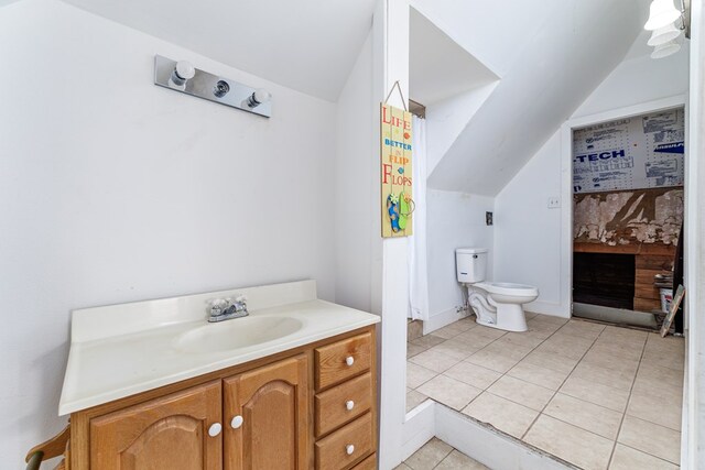 bathroom with vaulted ceiling, vanity, and toilet