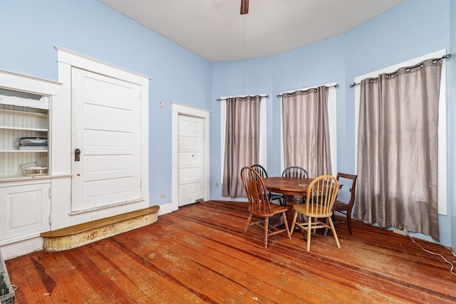 dining space with hardwood / wood-style flooring and ceiling fan