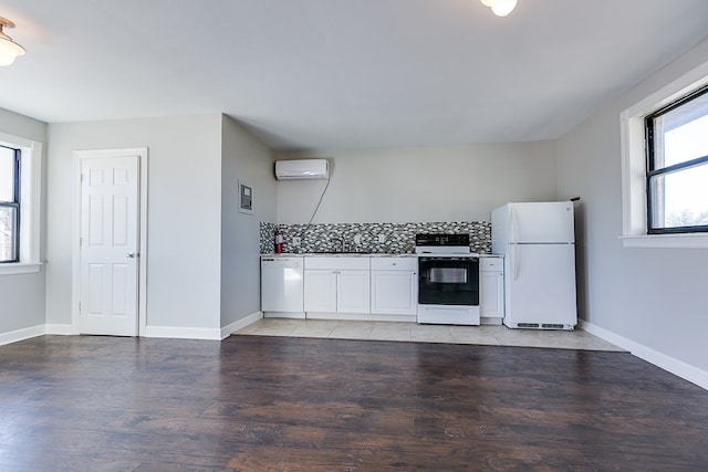 5438 S Loop 306, San Angelo, TX 76905 - kitchen featuring a sink, white appliances, light wood finished floors, an AC wall unit, and decorative backsplash