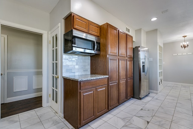 5438 S Loop 306, San Angelo, TX 76905 - kitchen with a notable chandelier, light stone countertops, marble finish floor, visible vents, and stainless steel appliances