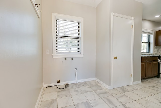 5438 S Loop 306, San Angelo, TX 76905 - washroom featuring laundry area, washer hookup, baseboards, and marble finish floor