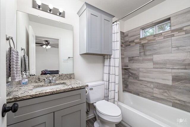 full bathroom featuring vanity, shower / bath combination with curtain, and toilet