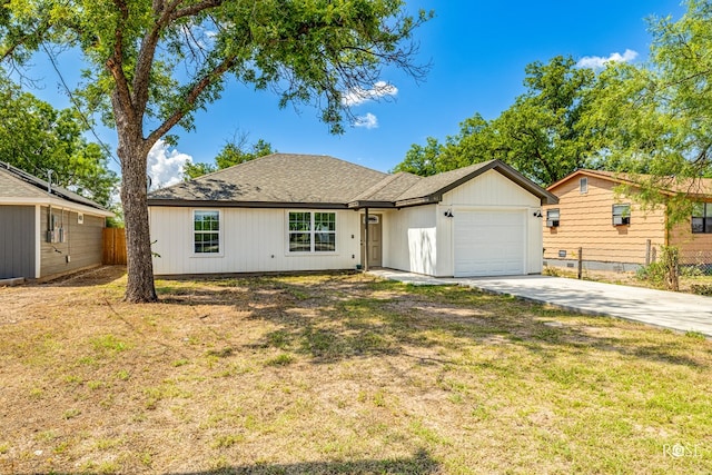 ranch-style house with a garage and a front yard