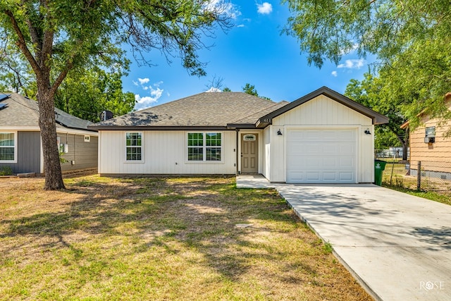 single story home with a garage and a front yard