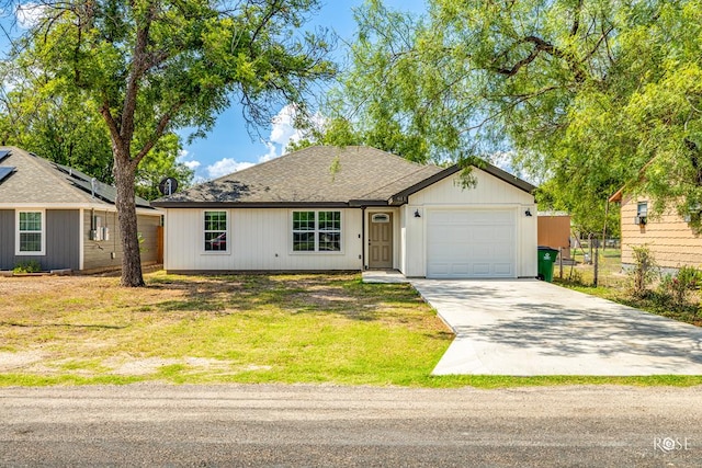 single story home with a garage and a front yard