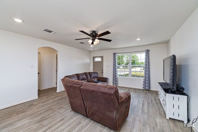 living room with ceiling fan and light hardwood / wood-style floors