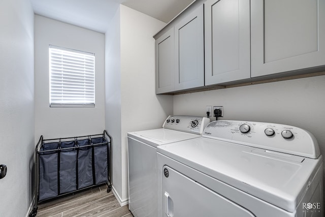 laundry area with cabinets and washing machine and clothes dryer