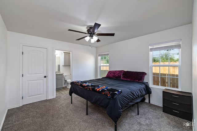 bedroom with carpet flooring, connected bathroom, and ceiling fan