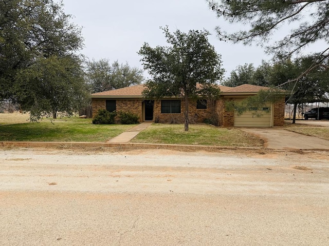 ranch-style home featuring a garage and a front lawn