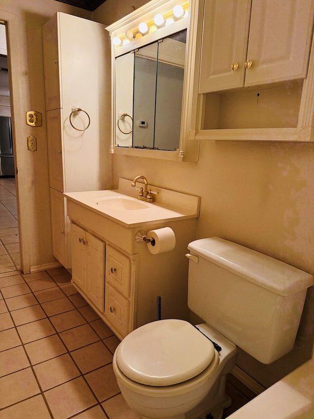 bathroom with vanity, tile patterned floors, and toilet