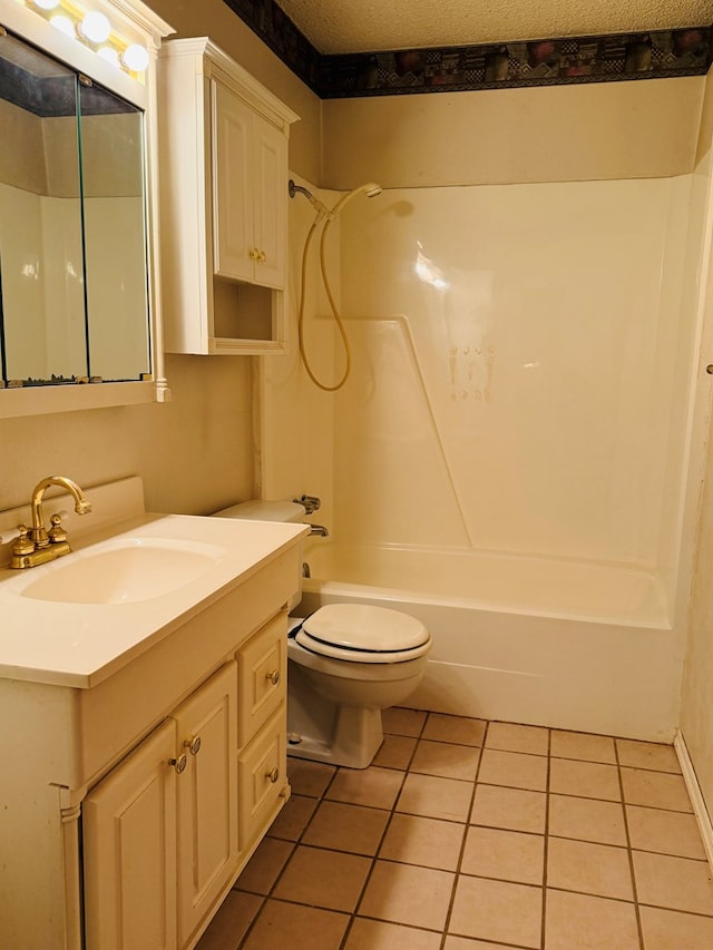 full bathroom featuring washtub / shower combination, toilet, a textured ceiling, vanity, and tile patterned flooring