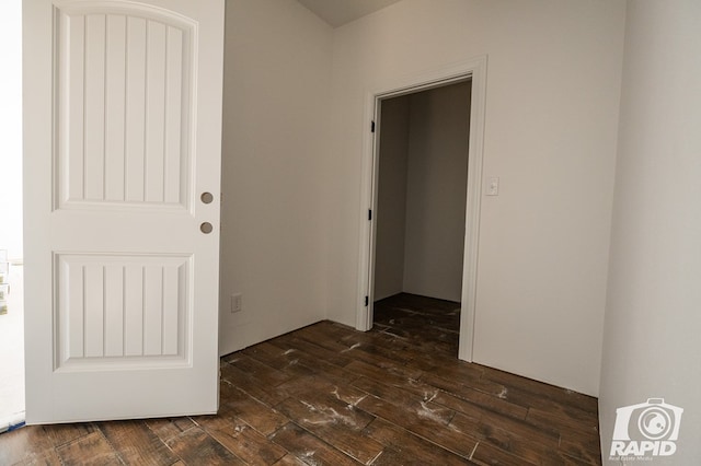 unfurnished room with dark hardwood / wood-style flooring