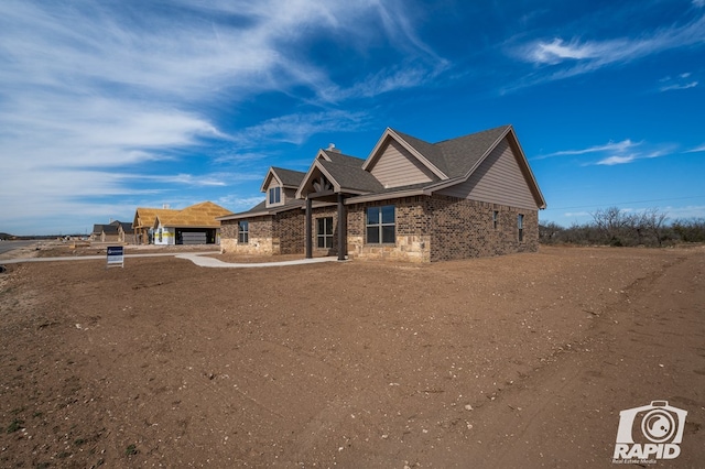 view of front facade with a garage and brick siding