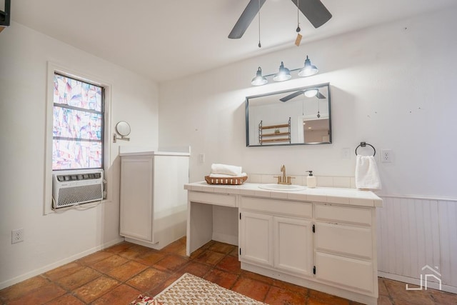 bathroom with wainscoting, cooling unit, vanity, and a ceiling fan