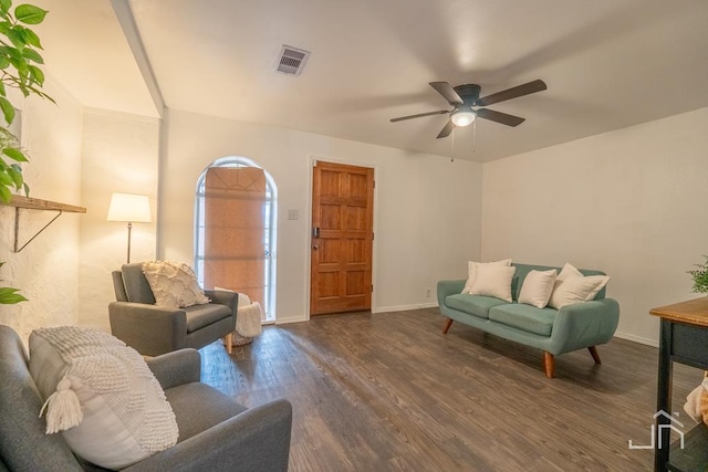 living area with visible vents, baseboards, dark wood finished floors, and a ceiling fan