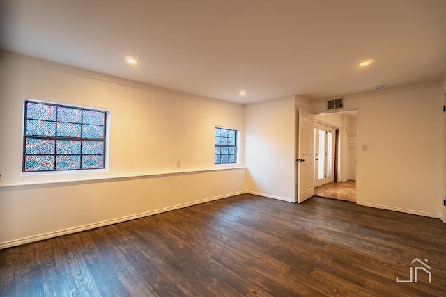 spare room with recessed lighting, visible vents, baseboards, and wood finished floors