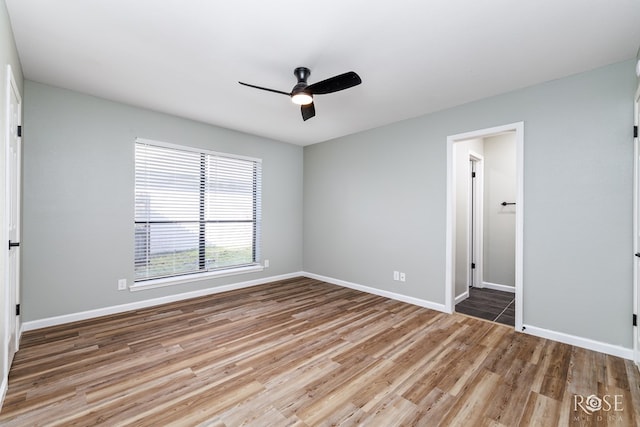 unfurnished room with hardwood / wood-style flooring and ceiling fan