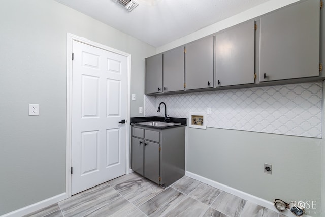 laundry room featuring washer hookup, sink, cabinets, and hookup for an electric dryer