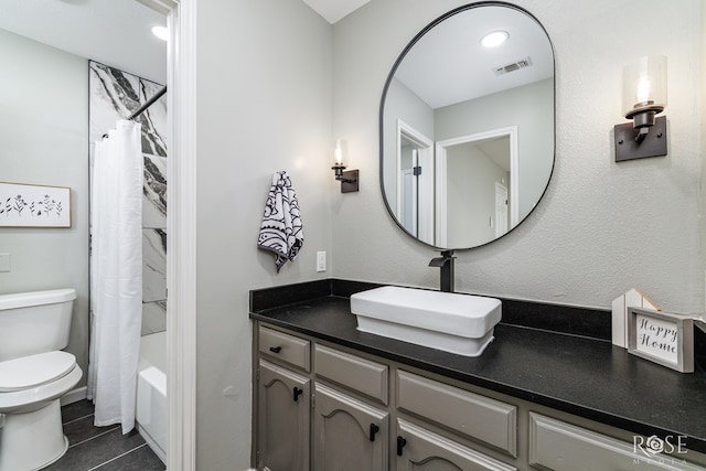 full bathroom featuring vanity, tile patterned floors, shower / bath combination with curtain, and toilet