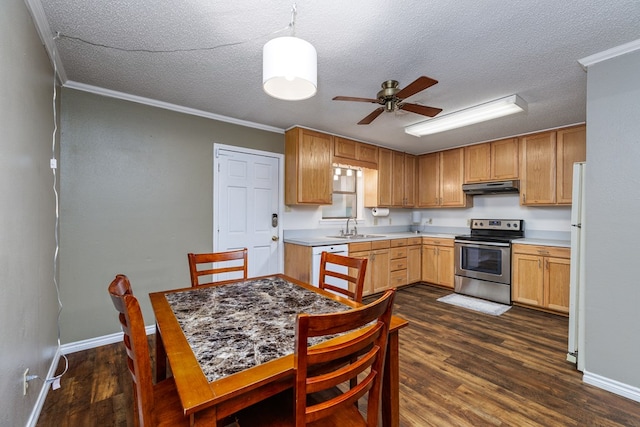 kitchen featuring white appliances, under cabinet range hood, dark wood-style flooring, and a sink