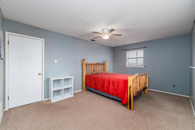 bedroom featuring carpet, visible vents, ceiling fan, a textured ceiling, and baseboards