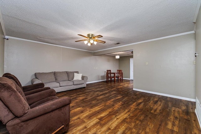 living room with ceiling fan, a textured ceiling, wood finished floors, baseboards, and crown molding