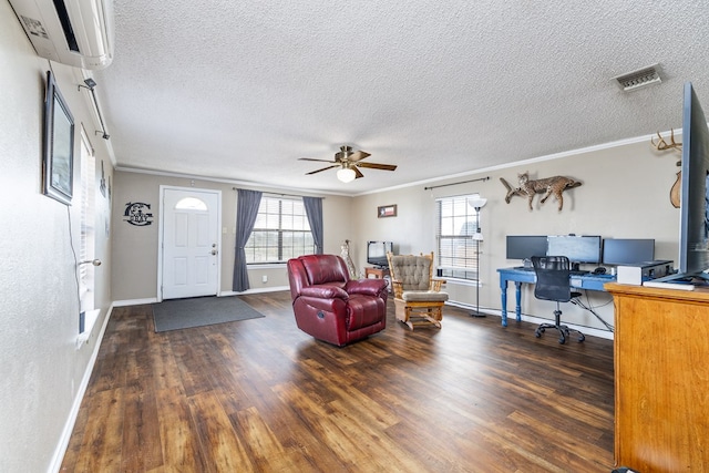 living room with crown molding, visible vents, an AC wall unit, and wood finished floors