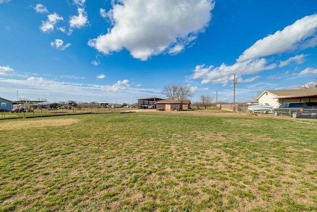 view of yard featuring a rural view and fence