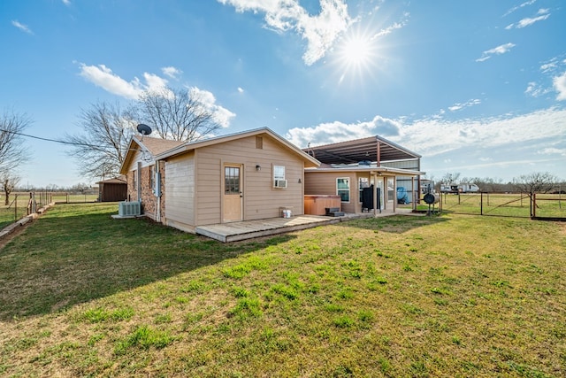 back of house with a yard, central AC unit, a gate, a deck, and a fenced backyard