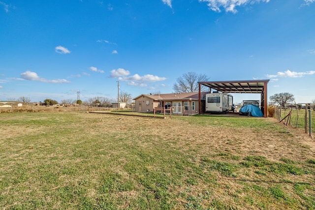 view of yard featuring a carport and fence