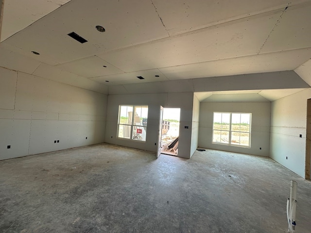 3121 Cedarhill Dr, San Angelo, TX 76904 - spare room featuring unfinished concrete flooring and vaulted ceiling
