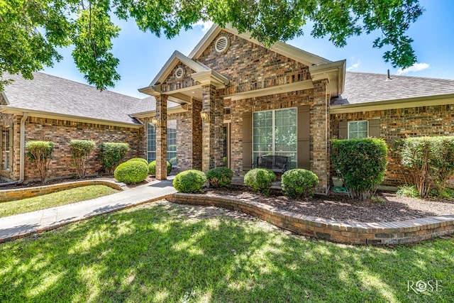 4833 N Bentwood Dr, San Angelo, TX 76904 - view of front of property featuring a shingled roof, a front yard, and brick siding