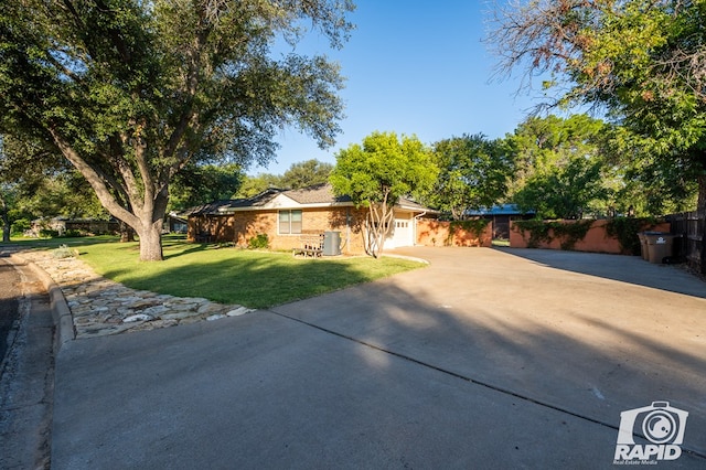 single story home with a front yard and central air condition unit